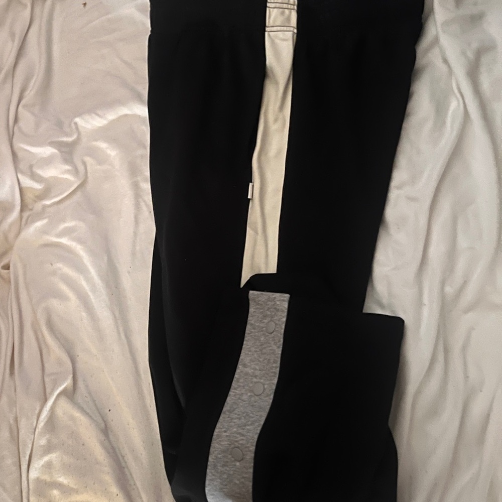 Fabletics sweat pants. 
Navy blue with white stripes on the sides